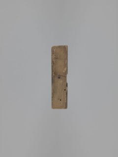 Double-sided gingerbread form. Obverse: female figure in a hat and a long patterned dress. Reverse: