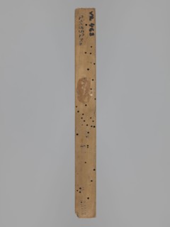 Double-sided gingerbread form. Obverse: female figure in a hat and a long patterned dress. Reverse: