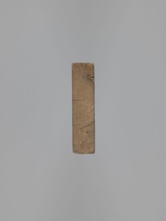 Double-sided gingerbread form. Obverse: female figure in a hat and long patterned dress; Reverse: