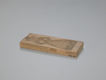 Double-sided gingerbread form. Obverse: female figure in a hat and long patterned dress. Reverse: