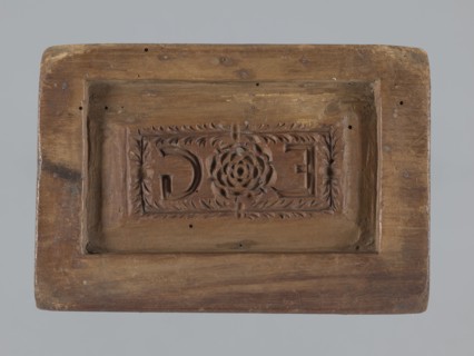 Double-sided gingerbread mould. Oblong rectangular mould; obverse: oval frame containing a
