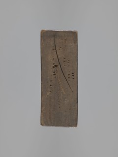 Double-sided gingerbread mold. Obverse: male figure in a high hat and a fur-lined jacket seated on
