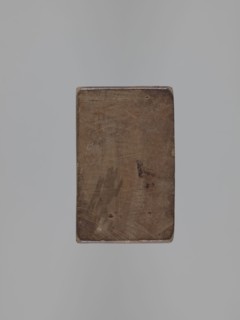 Double-sided gingerbread mould. Obverse: stylised elongated fish covered with scales, shown in