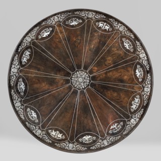 Table with round tilting top on a shaft composed in the middle of three balusters, forked at the