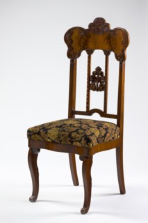 Mahogany chair with a padded seat and a high openwork backrest, with carved decoration. Square