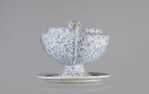 Vase on base. Semi-ovoidal vase on a low pedestal base with sharply broken edges and tapering with