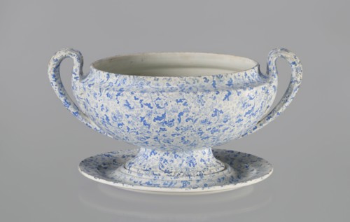Semi-ovoidal vase on a low pedestal base with sharply broken edges and a concave taper. Vertical