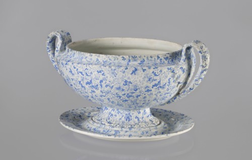 Semi-ovoidal vase on a low pedestal base with sharply broken edges and tapering concave profile.