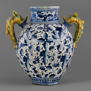 A two-handled, ovoid pharmacy vase with a cylindrical neck, gently flaring at the rim. On the belly