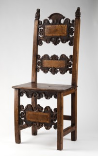 Chair, carved, with a board seat and a high backrest composed of two boards with a wavy, openwork