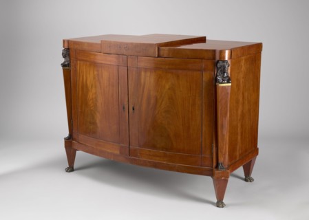 A one-piece cabinet with a slightly rounded front closed by double doors, supported by four low,