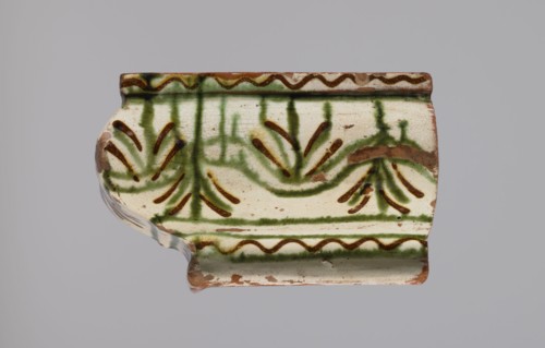 Cornice tile fragments 4, painted with a wavy twirl pattern; tile cullet; stoves; plant