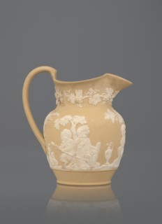 Oinochoe jug, cane ware pottery, beige-sand with a ribbon handle; around the belly, white reliefs: