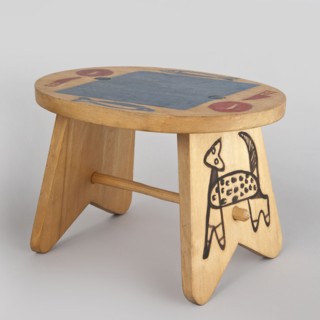 Table from a set of doll furniture. Wooden table with an oval top resting on stringer supports,