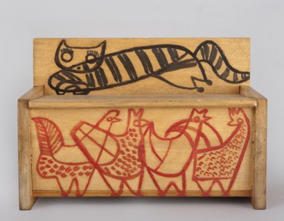 A wooden bench from a set of doll furniture. Wooden bench with a box closed by a flap forming a