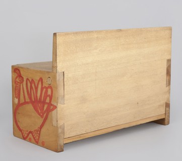 Wooden bench from a set of doll furniture. Wooden bench with a box closed by a flap forming a seat.