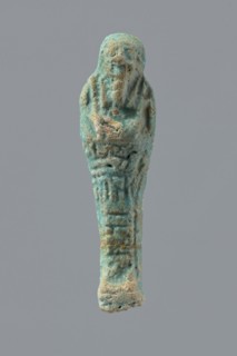 Ushabti, mummy-shaped funerary figurine wrapped in a shroud with its arms crossed on its chest,