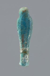 Ushabti, mummy-shaped funerary figurine wrapped in a shroud with its arms crossed on its chest,
