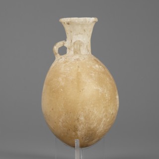 Flask-shaped vessel with a spherical, flattened belly, narrow widening neck and three small