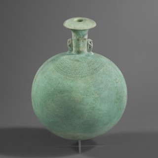 New Year's canteen. Flat round faience canteen with a narrow short neck ending in a chipped spout