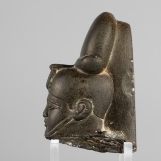 Fragment of a figurine of the god Khonsu – head. Depicted wearing a lock of youth and a disc
