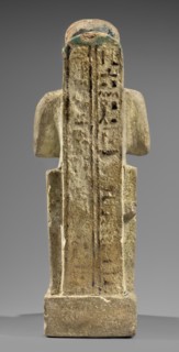 Figurine of the god Ptah. Figural sculpture of Ptah seated on a throne on a base in the shape of