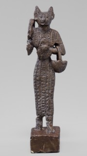 Figurine of the goddess Bastet. Figurine of a goddess with a cat's head, dressed in a