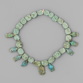 Necklace of amulets and beads; Cornflowers, face of Hathor, and flat fluted plates with crosses. ca