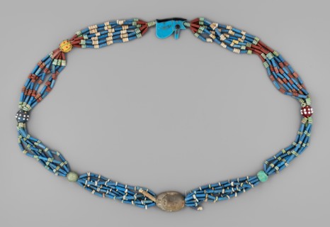 Necklace with a scarab and an udjat eye. Necklace composed of six rows of faience tubular and