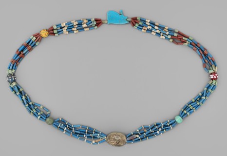 Necklace with a scarab and an udjat eye. Necklace composed of six rows of faience tubular and
