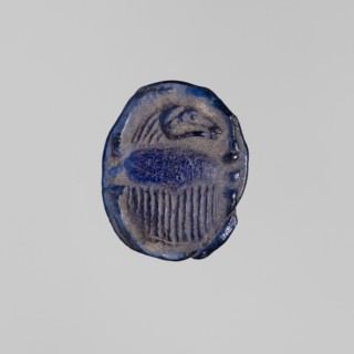 Scarab with a ram's head, ram's head ornament, sacred animal protective amulet in navy blue glass;