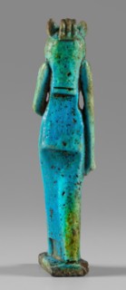 Amulet - figurine of a lion-headed goddess. A lion-headed goddess, in a tripartite wig and a narrow