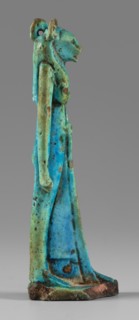Amulet - figurine of a lion-headed goddess. A lion-headed goddess, in a tripartite wig and a narrow