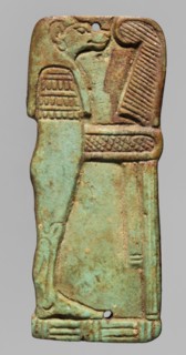 Amulet - plaque with a depiction of the god Hapi. Relief figurine of the god Hapi, shown in right