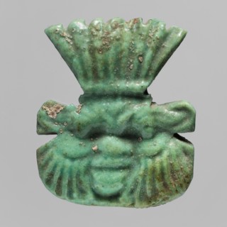 Amulet — plaque with the head of the god Bes;, Amulet in the form of a plaque with a relief