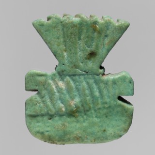 Amulet plaque with the head of the god Bes, amulet in the form of a plaque with a relief depiction