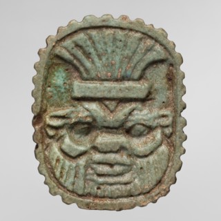 Amulet plaque with the head of the god Bes; plaque amulet, Egyptian deity Bes, wearing crowns. Late