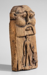 Magical stele topped with the mask of the god Bes. Magical stele cippus depicting in the lower