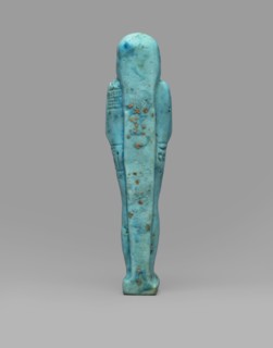 Ushabti Wahibre-em-achet. Mummy-shaped funerary figurine shabti made of blue faience with black
