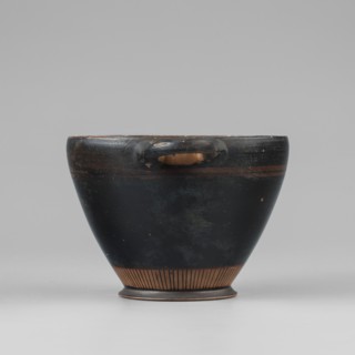 Black-finished skyphos. Thin-walled skyphos with a slightly inward-curved rim. Horizontal handles