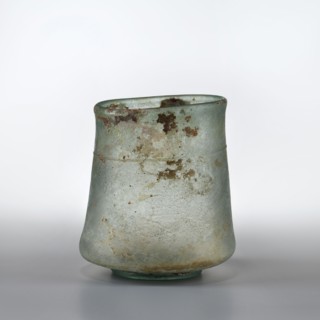 Mug with walls widely flared at the bottom above the ring-shaped foot, slightly convex and forming