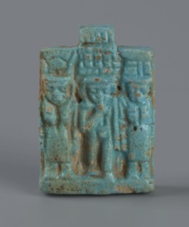 Amulet – plaque with a triad of deities: Harpocrates Horus, Isis, Nephthys. Amulet in the shape of