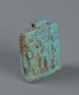 Amulet – plaque with a triad of deities: Harpocrates Horus, Isis, Nephthys. Amulet in the shape of