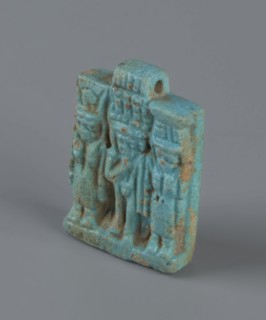 Amulet – plaque with a triad of deities: Harpocrates Horus, Isis, Nephthys. Amulet in the shape of