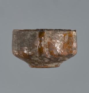 Miniature scoop with a flat bottom; walls widen diagonally to 1/3 then run vertically upward; one
