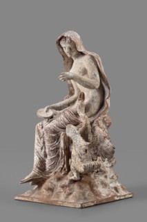 Figurine of Leda with a Swan, A woman sits on a rock and feeds a swan standing next to her. She is