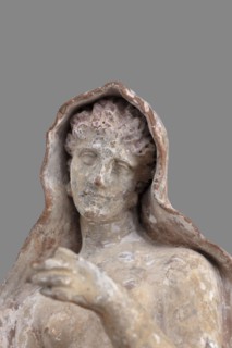 Figurine of Leda with a Swan, A woman sits on a rock and feeds a swan standing next to her. She is