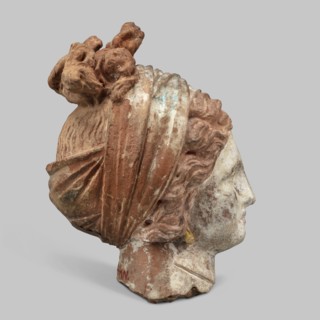 Head of a woman. Female head, fragment of a larger figurine. The head is tilted slightly to the
