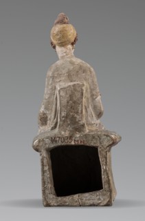 Figurine of a woman. A girl sitting in a chair is dressed in a soft white chiton over which a blue,