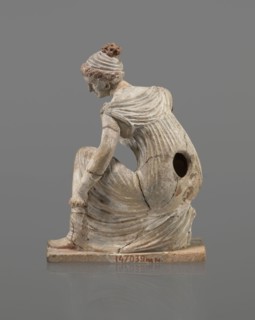 Terracotta figurine of a girl throwing dice. Figurine of a crouching girl throwing dice: weight of